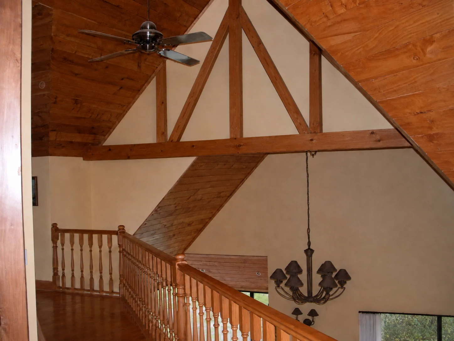House Additions mezzanine with exposed timber framing and double-height space